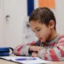 Un enfant fait ses devoirs à l'école. 